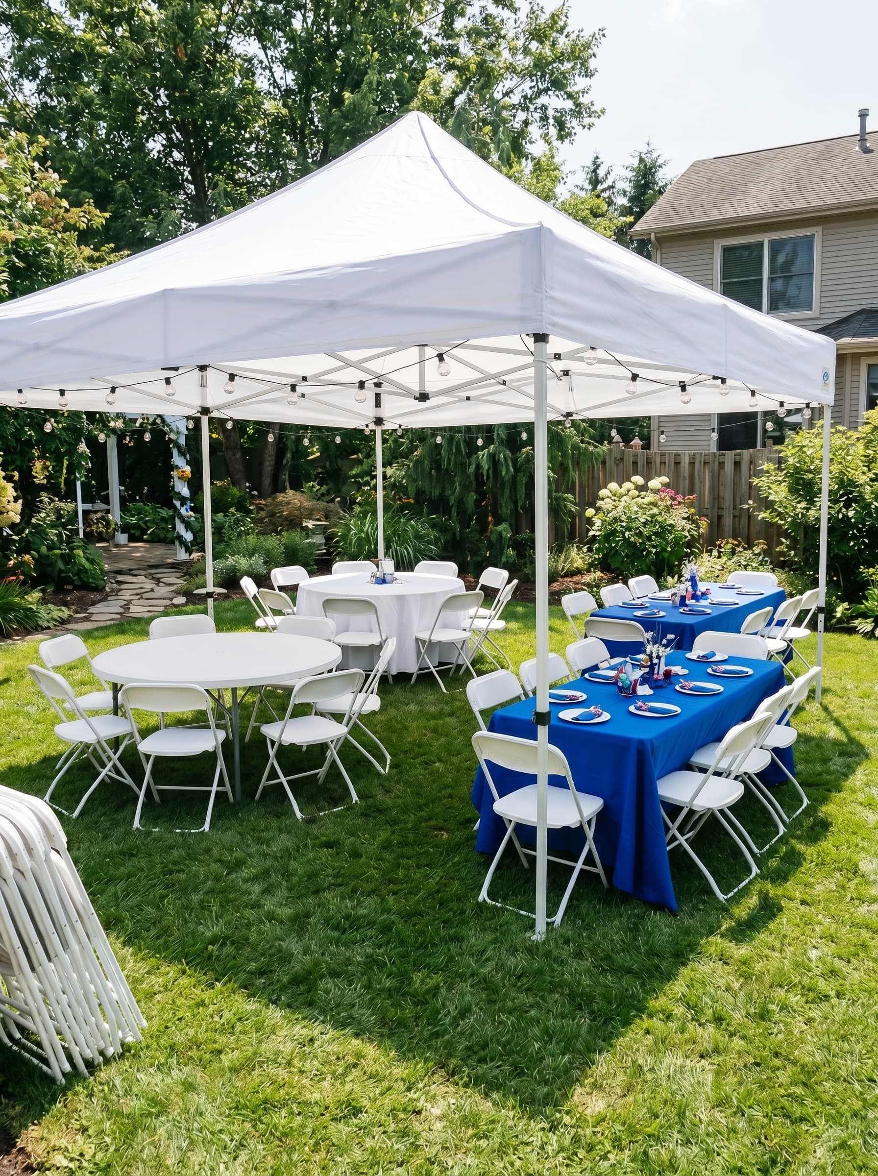 Outdoor party rental setup with tables, chairs, and canopy tent